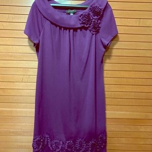 Purple knee length dress with flower detail